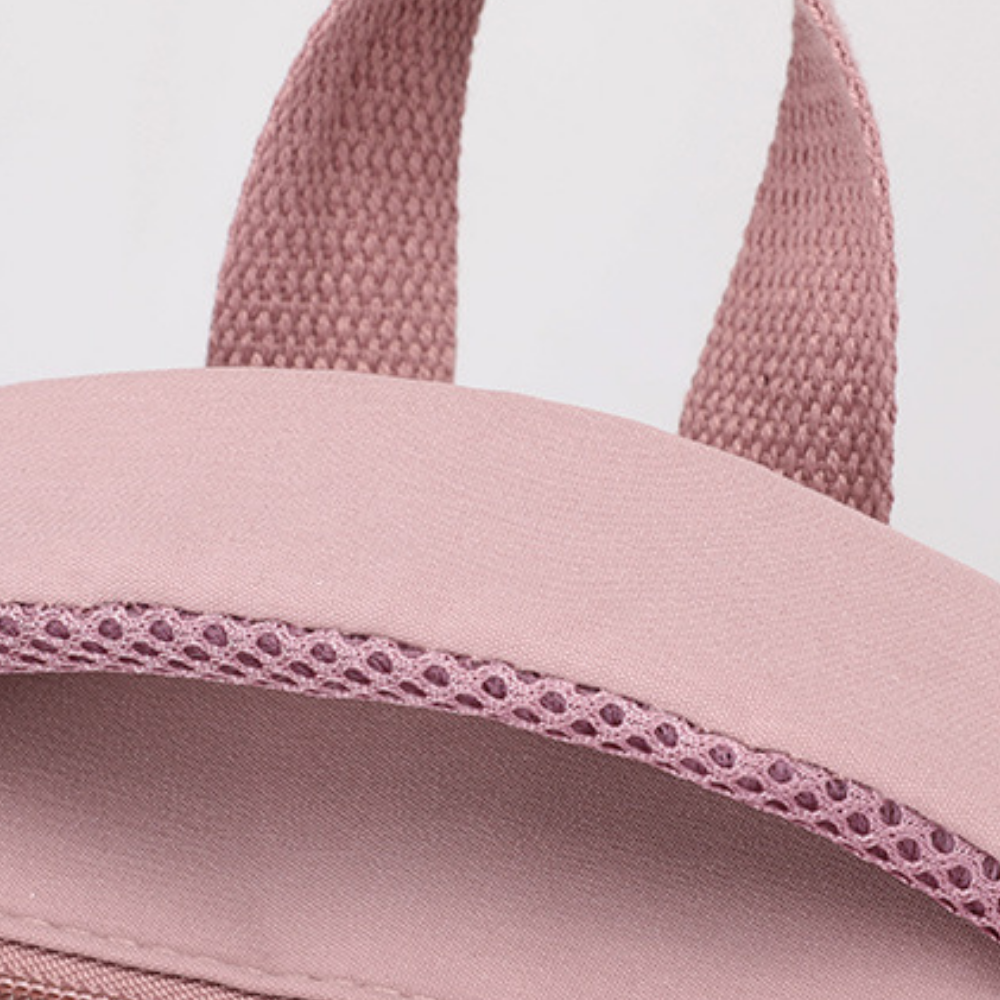 Sac à dos scolaire en polyester, détail des coutures renforcées, coloris rose