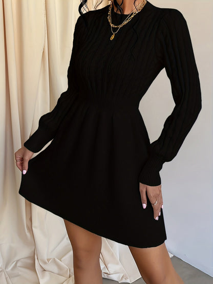 Détail du tricot torsadé sur le buste de la robe pull