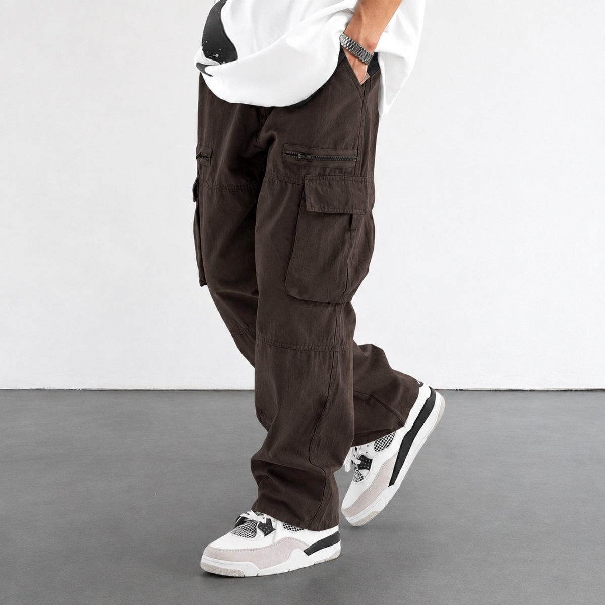 Pantalon cargo homme marron, coupe large, vue de profil avec poches à rabat et poche zippée