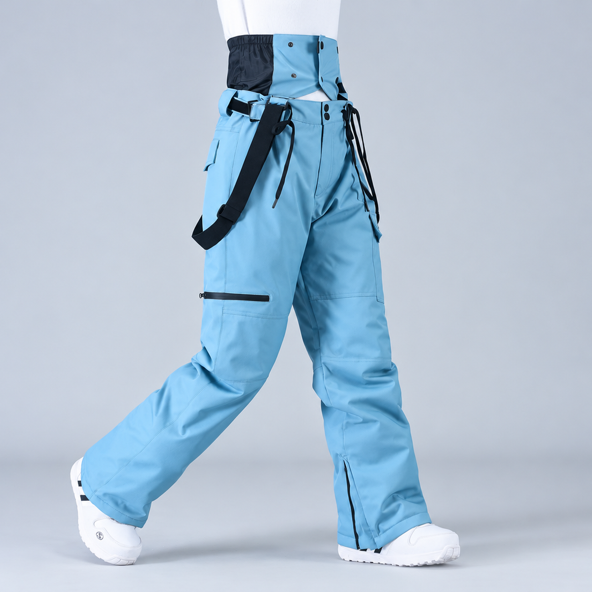 Pantalon de snowboard unisexe bleu, vue de profil montrant les bretelles et les poches cargo