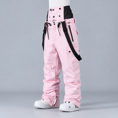 Pantalon de snowboard unisexe rose, vue de profil montrant les bretelles et les poches cargo